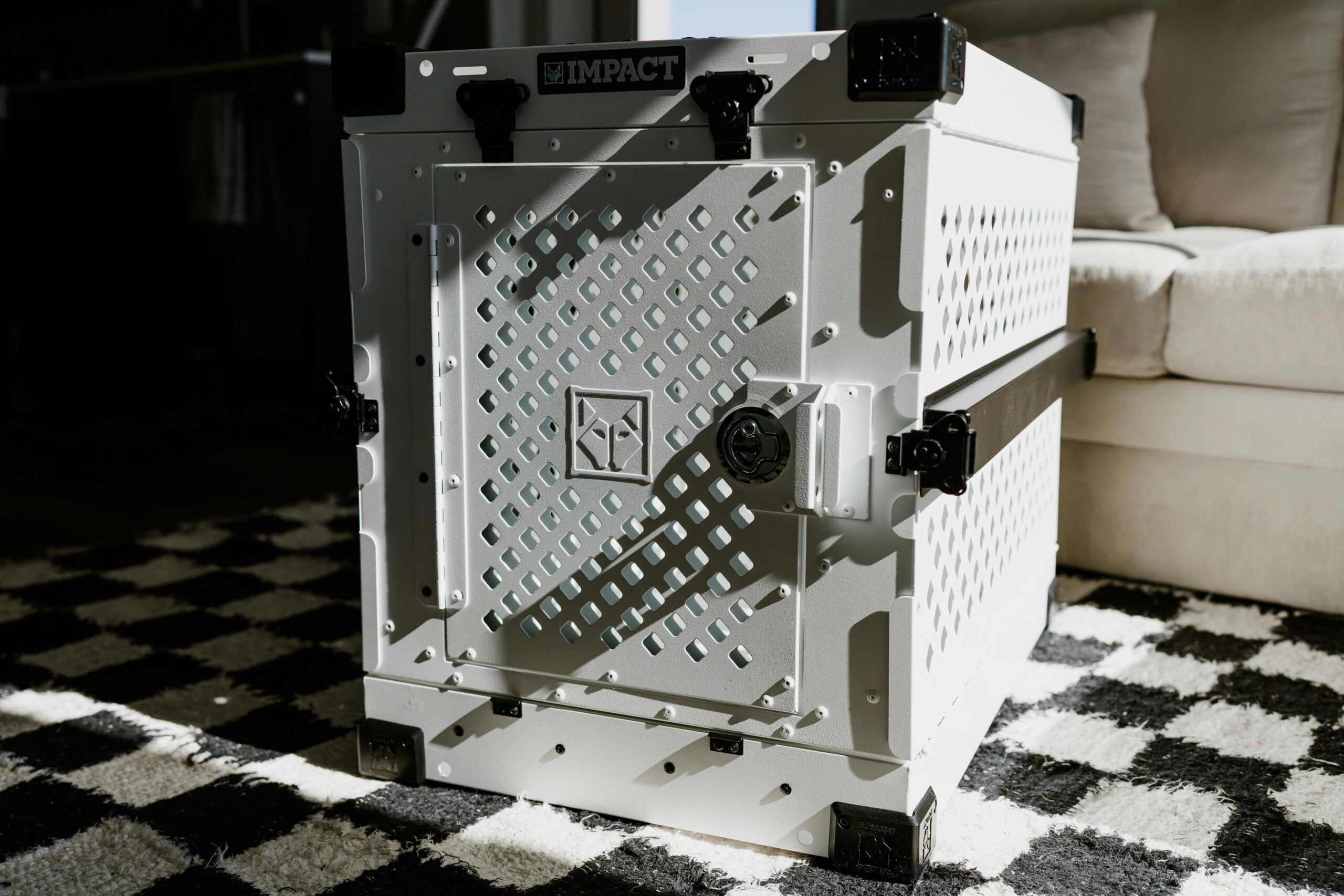 High-quality aluminum dog crate in modern living area, perfect for pet safety and durability.